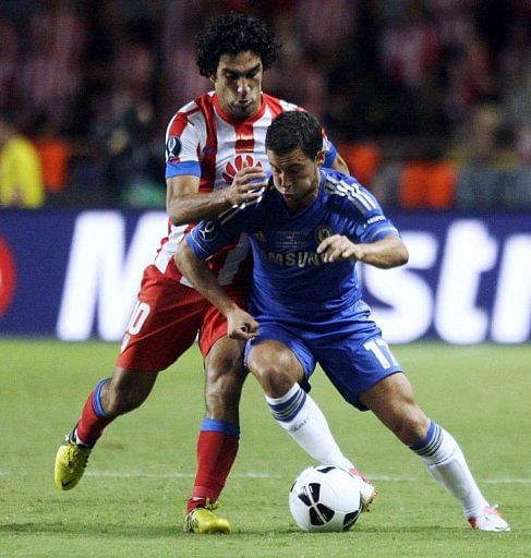 Chelsea's forward Eden Hazard (R) clashes with Atletico Madrid's forward Arda Turan
